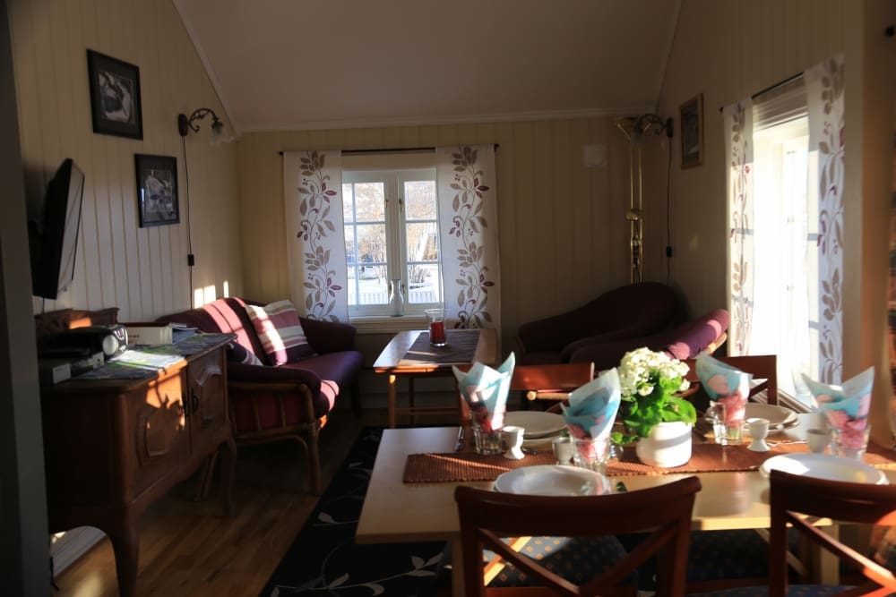 Dining table and living room in Messa 2 floor, holiday house in Lyngen
